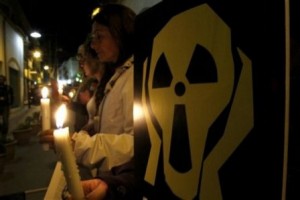 Greek and Turkish anti-nuclear activists hold candles and banners during a rally to mark the 25th anniversary of the Chernobyl nuclear accident at Ledras street at the U.N buffer zone in Nicosia, Cyprus, Tuesday, April 26, 2011. Greek and Turkish Cypriots activists gathering and holding lighted candles, they formed a human chain across the United Nations controlled buffer zone to signify their joint opposition to "dangerous" nuclear power whose risks they say outweigh its benefits. They also voiced their concern over Turkey's plans to build a nuclear power plant on its southern coast, some 90 kilometers away from Cyprus' northern coastline. Citing Japan's Fukushima Dai-ichi nuclear plant disaster, activists say construction of such a plant is foolhardy because the site, Akkuyu Bay, is situated "very close to a dangerous seismic fault line." (AP Photo/Petros Karadjias)