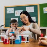 Asian school teacher and students in science class